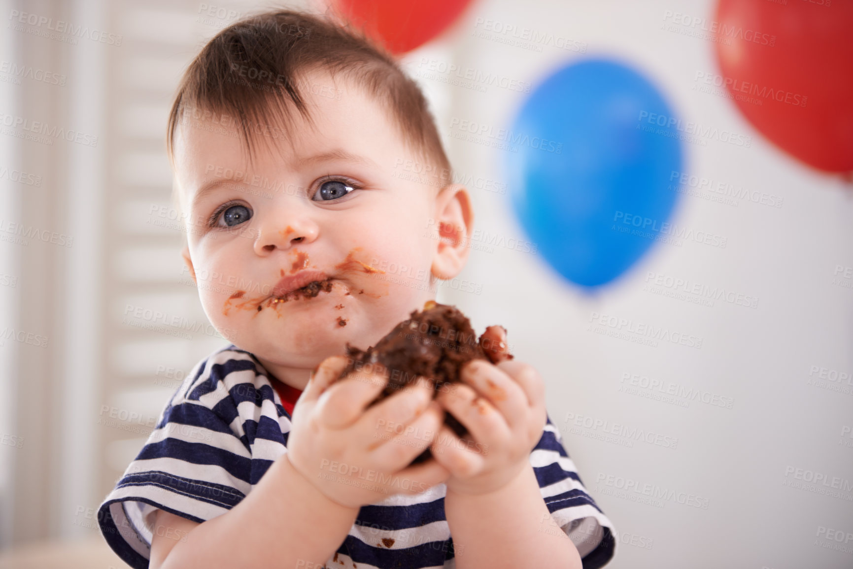 Buy stock photo Shot of a baby boy eating some cake on his birthday