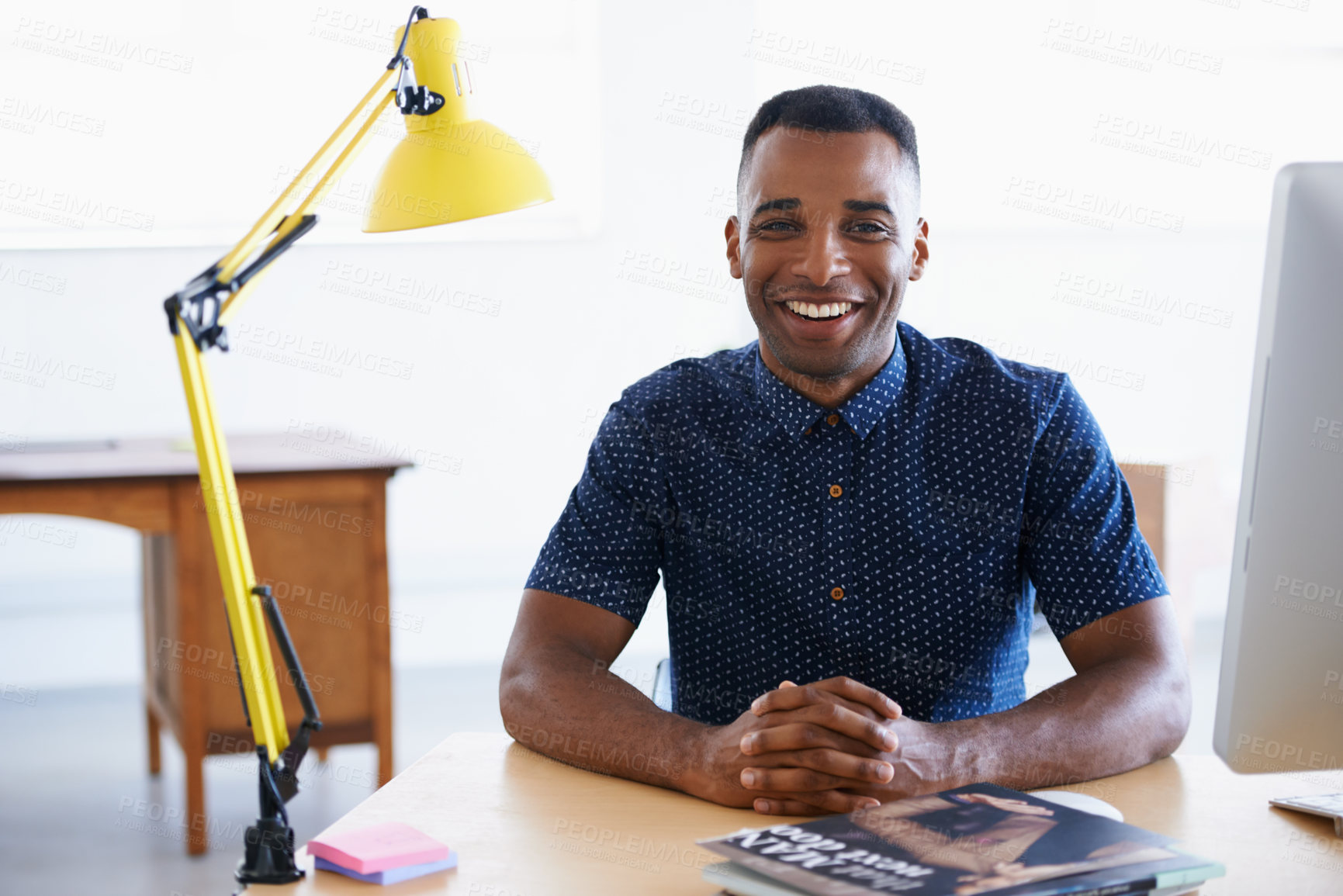 Buy stock photo Young businessman, portrait and happy in office by desk, consultant and creative in career. Smile, black man or positive face of journalist in co working space or professional for ambition in company
