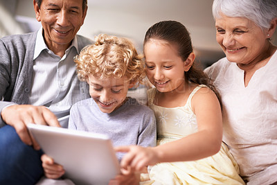 Buy stock photo Happy family, grandparents and kids with tablet for entertainment or social media on sofa at home. Grandma, grandpa and children with smile, hug and love on technology for bonding or game at house