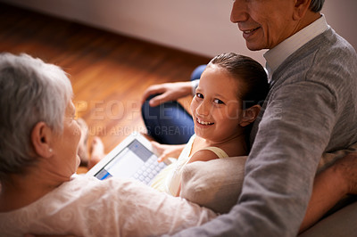 Buy stock photo Child, grandparents and tablet on couch in home or online game or communication, teaching or connection. Elderly couple, retirement and girl or internet learning in apartment, development or bonding