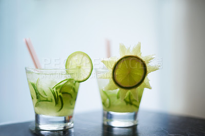 Buy stock photo Two beverages in glasses decorated with cucumbers 