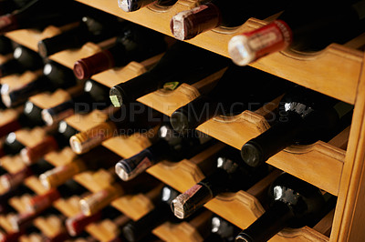Buy stock photo Wine cellar, bottle and storage on rack in basement for restaurant stock, winery and shelf with alcohol display. Warehouse, drinks collection and beverage stack in vineyard with arrangement and row 