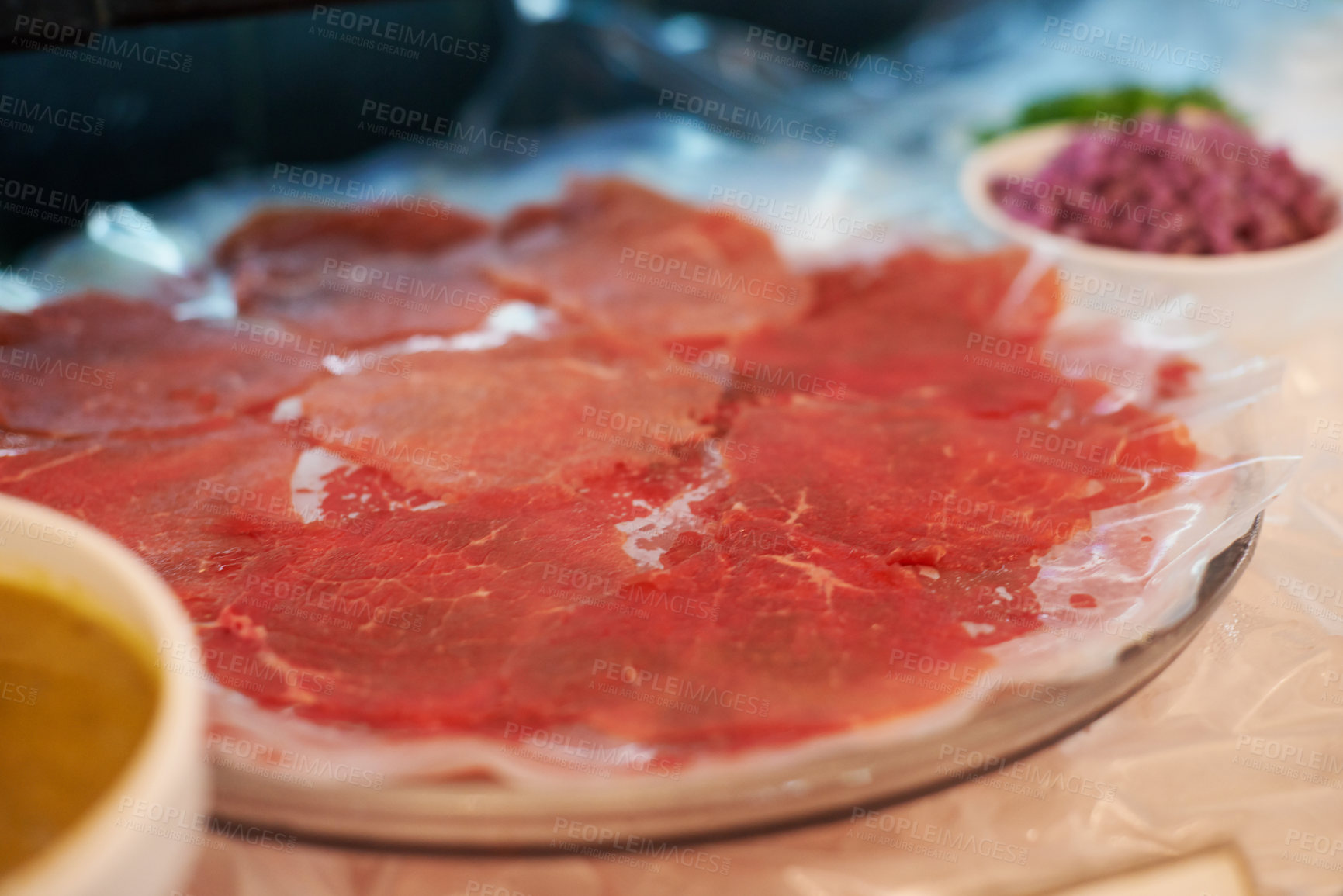 Buy stock photo Carpaccio, closeup and food on plate for dinner with appetizer, fine dining and buffet of raw meat in restaurant. Beef, seafood and protein meal on table for nutrition, snack or lunch at social event