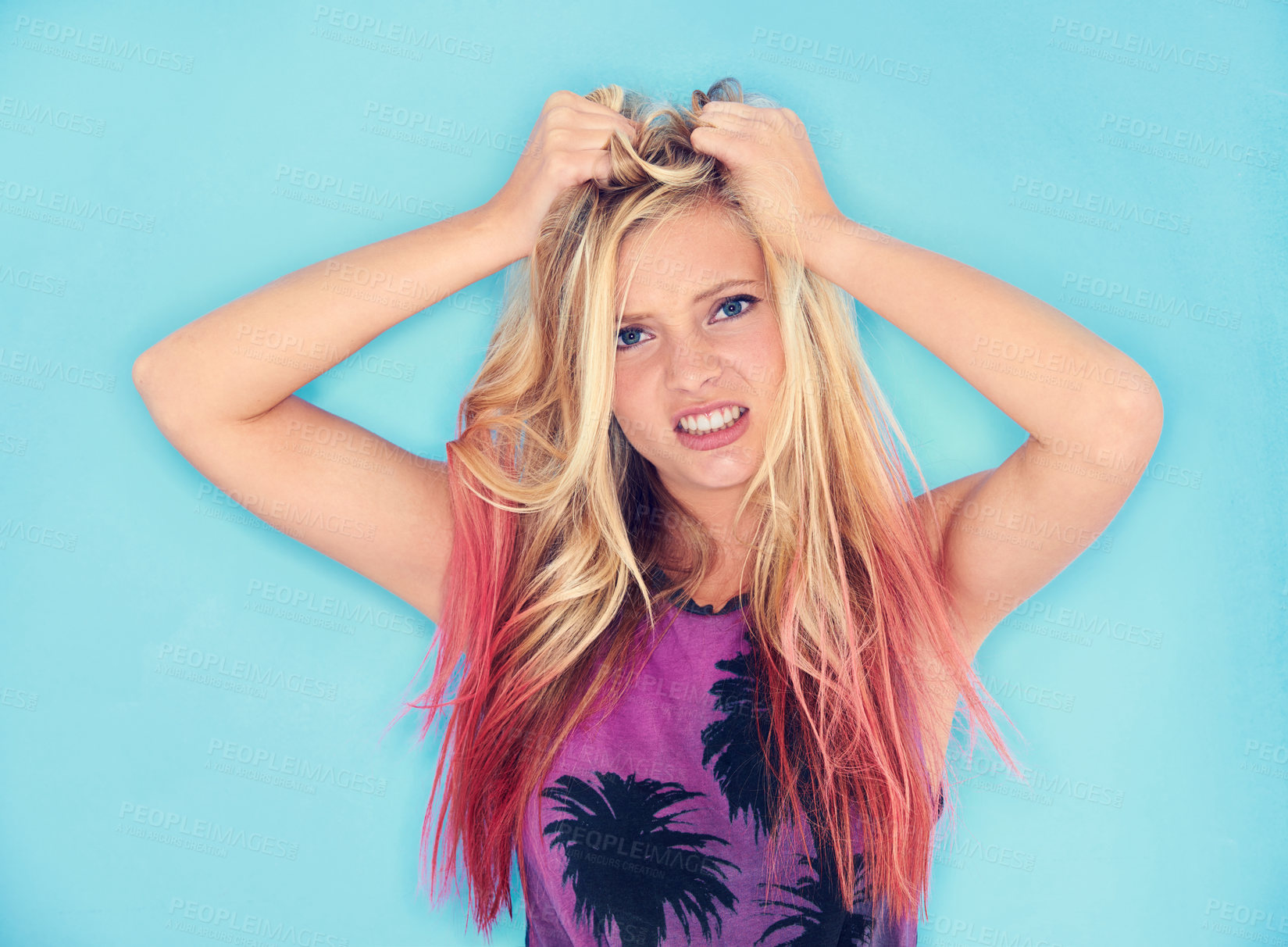 Buy stock photo A trendy young woman pulling her hair in frustration