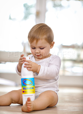 Buy stock photo Shot of a little baby playing with a bleach bottle