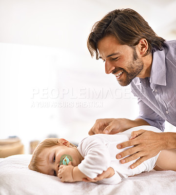 Buy stock photo Father, baby and happiness with play in home for healthy development, parenting and bonding in bedroom. Family, child and man with face, pacifier and comfort for relax, love and care on bed in house 