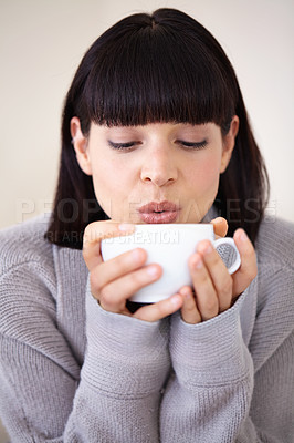 Buy stock photo Coffee, woman and blowing drink in home, calm and relax at breakfast for energy in the morning. Cool down, tea and person with hot espresso in cup, beverage and fresh cappuccino for health in house