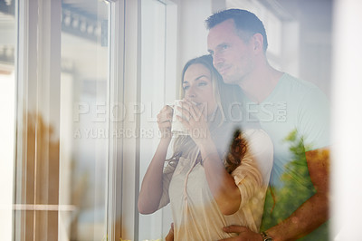 Buy stock photo Cropped shot of a happily married couple drinking coffee in the morning