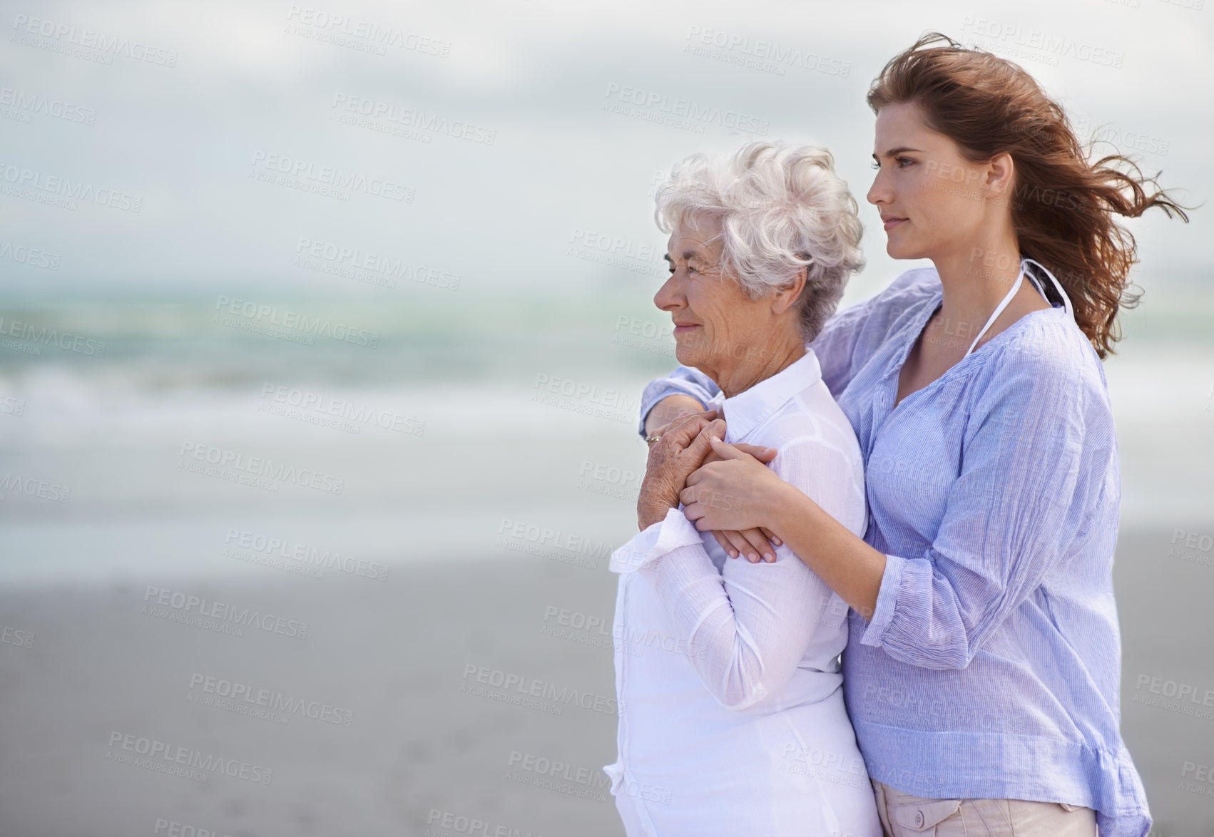 Buy stock photo Beach, young woman and her senior mother embrace or look at horizon outdoors. Mock up, free and hugging elderly woman with adult daughter or at sea or ocean thinking for affection and leisure 