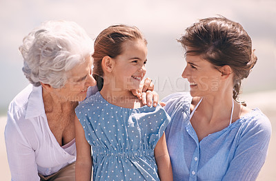 Buy stock photo Smile, wind and family on beach in summer together for outdoor travel, holiday or vacation. Face of grandma, mother and daughter in nature for generation bonding at coast or tropical weekend getaway