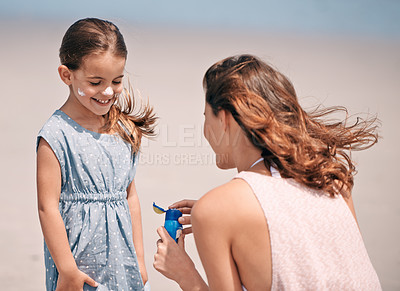 Buy stock photo Happy mother, child and sunscreen bottle at beach for summer holiday, vacation or travel. Girl, kid or mom apply sunblock cream outdoor for protection, health or skincare of family together in nature