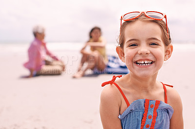 Buy stock photo Portrait, smile and little girl on beach in summer with family for travel, holiday or vacation. Face, relax and sunshine with happy young child on sand by ocean or sea for tropical weekend getaway