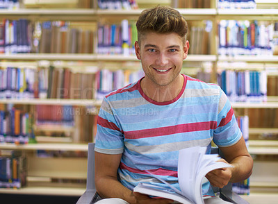 Buy stock photo Portrait of a handsome young college student studying in the library