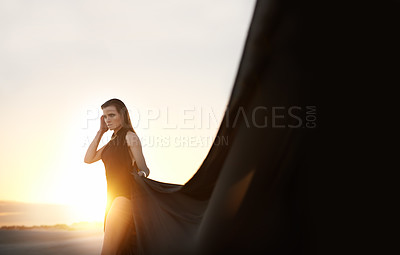 Buy stock photo Sunset, woman and fabric in wind outdoor for summer holiday, vacation or travel. Fashion, person and silk in the air for freedom, adventure and breeze in nature with serious girl thinking on mockup