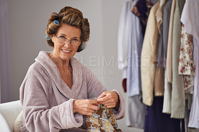 Buy stock photo Full length shot of a senior woman knitting at home