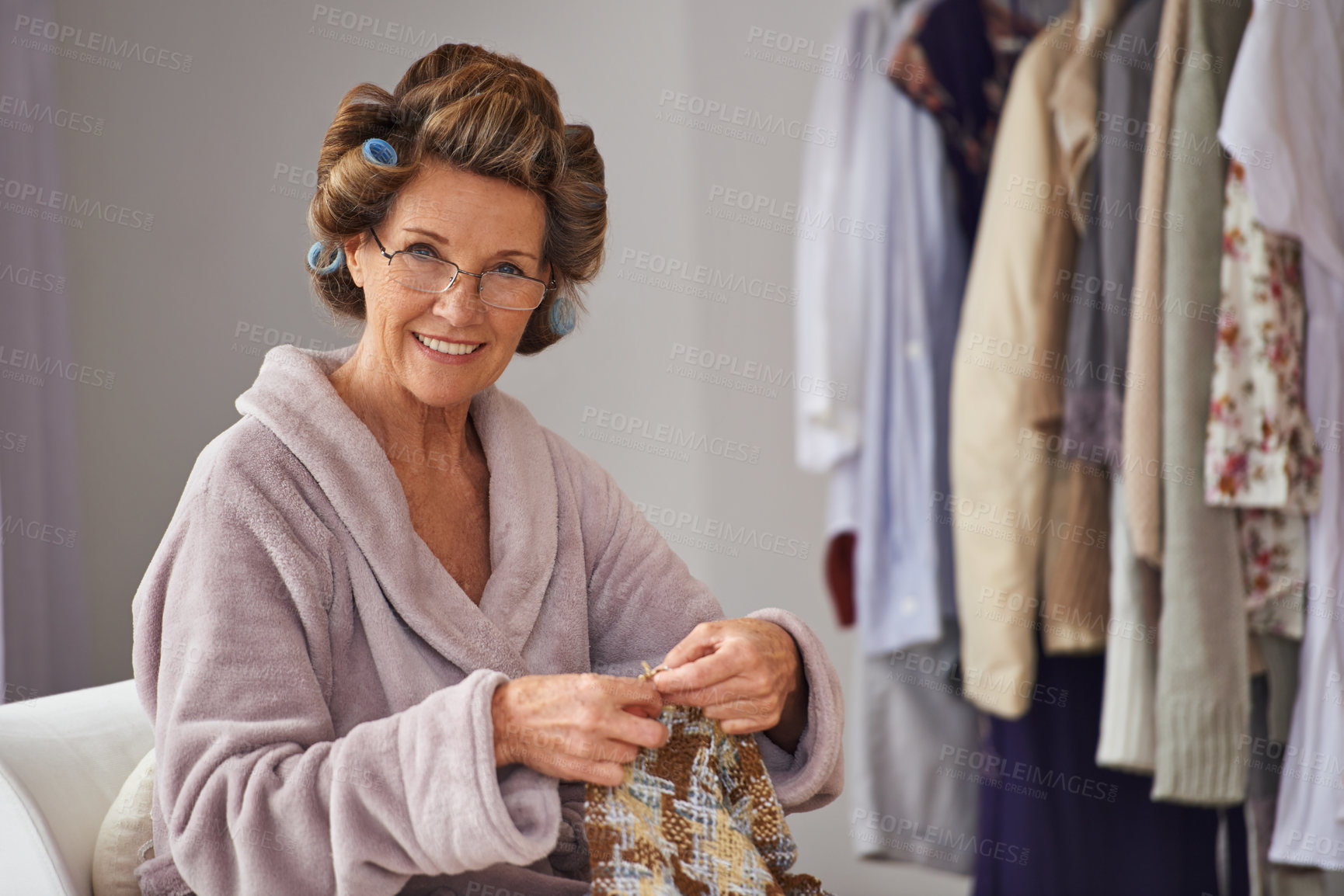 Buy stock photo Full length shot of a senior woman knitting at home