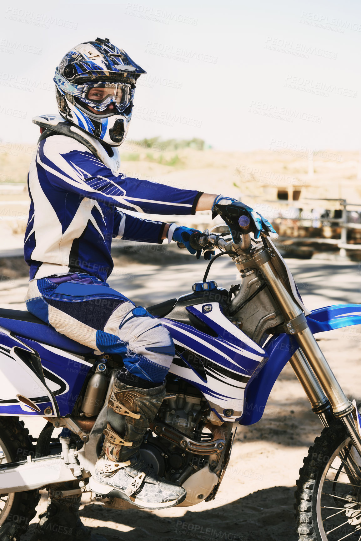 Buy stock photo Motorcycle, extreme sport and portrait for person on trail for competition, race or games with speed. Racer, motorbike and helmet for contest, motor cross and fast transport with sunshine in desert