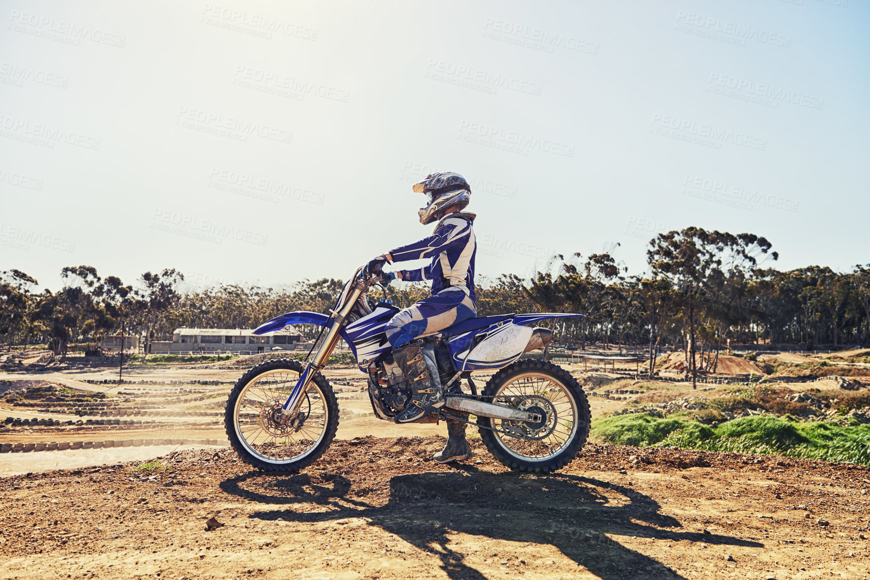 Buy stock photo Man, motorbike and outdoor on trail for extreme sport in profile on dirt, path or countryside in summer. Person, motorcycle and gravel on road with vehicle, machine or fast transport in competition