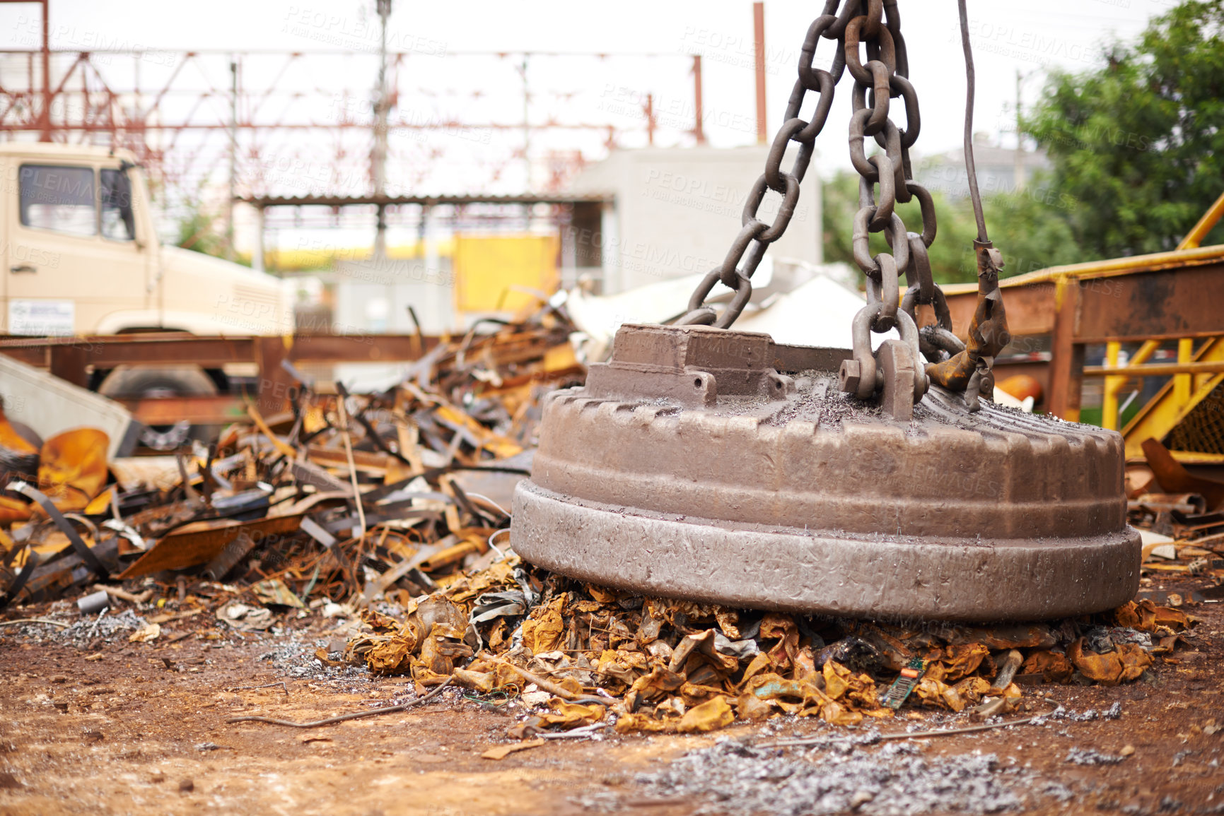 Buy stock photo Cropped shot of a large magnet collecting garbage at a scrapyard