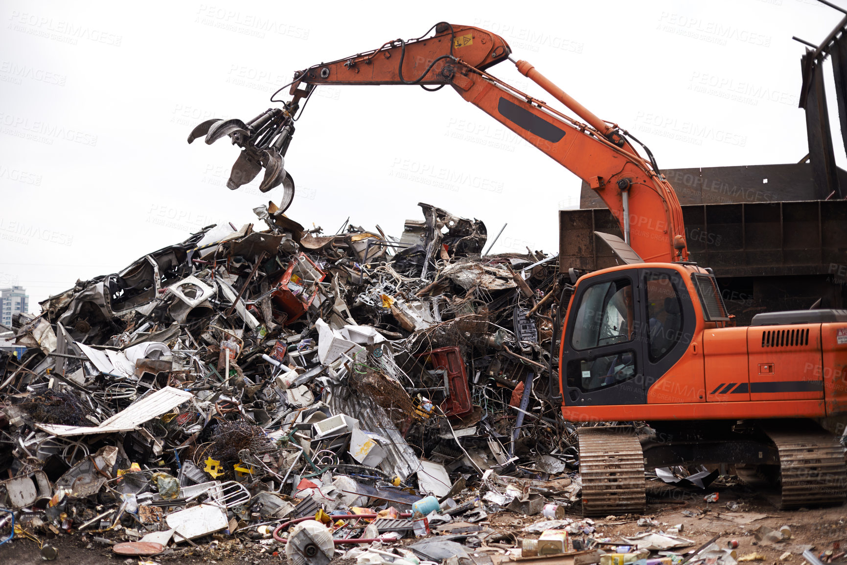 Buy stock photo Cropped shot of a crane at work in a dumpsite