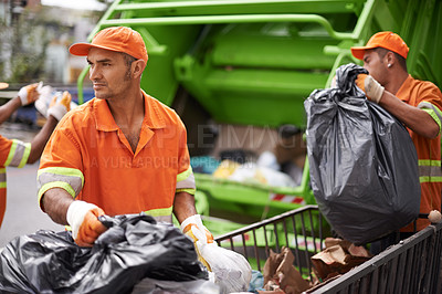 Buy stock photo Cropped shot of a garbage collection team at work