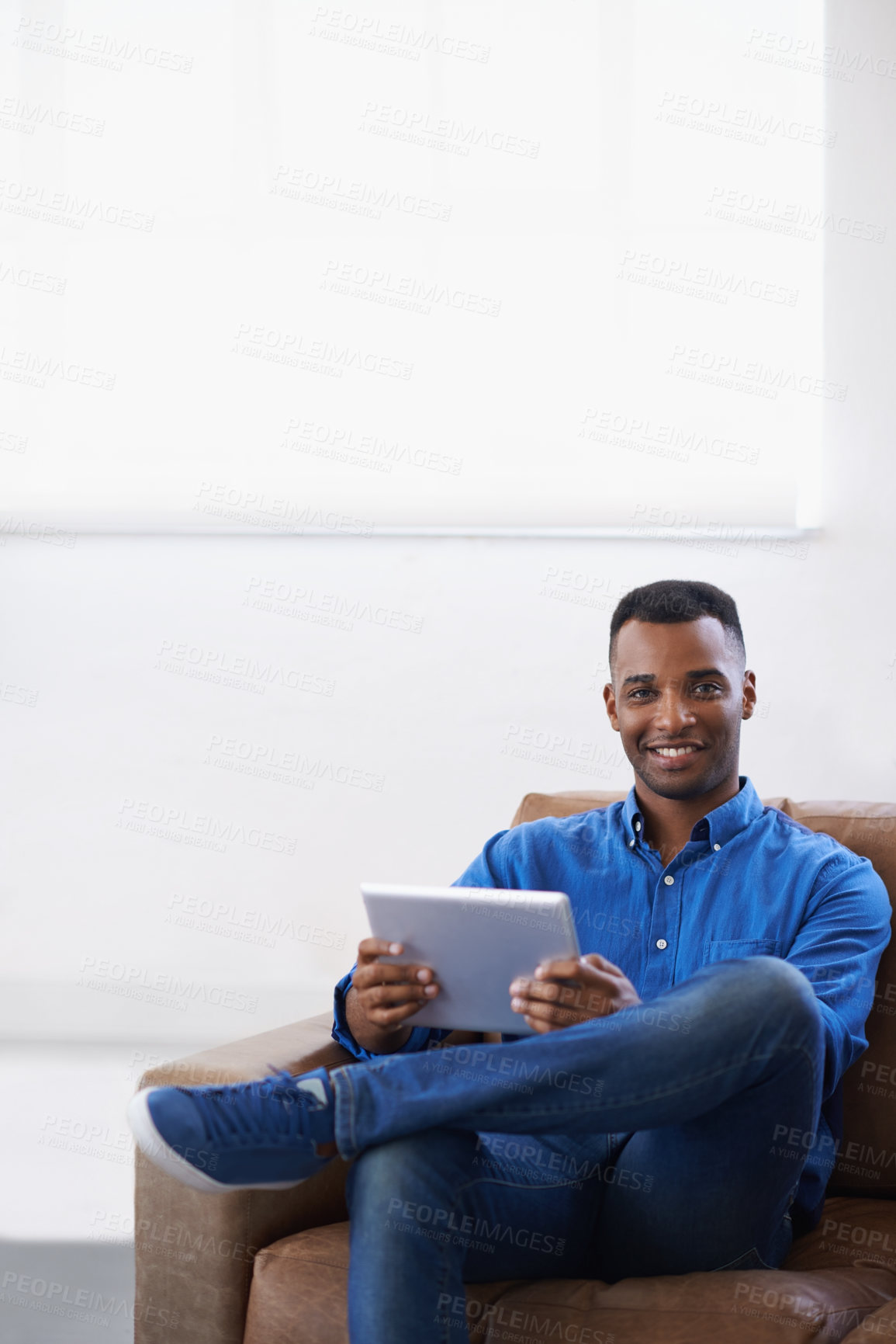 Buy stock photo Man, tablet and online in portrait at home, subscribe and internet for website or blog. Black male person, smile and streaming entertainment on couch, mockup space and app for shopping on weekend