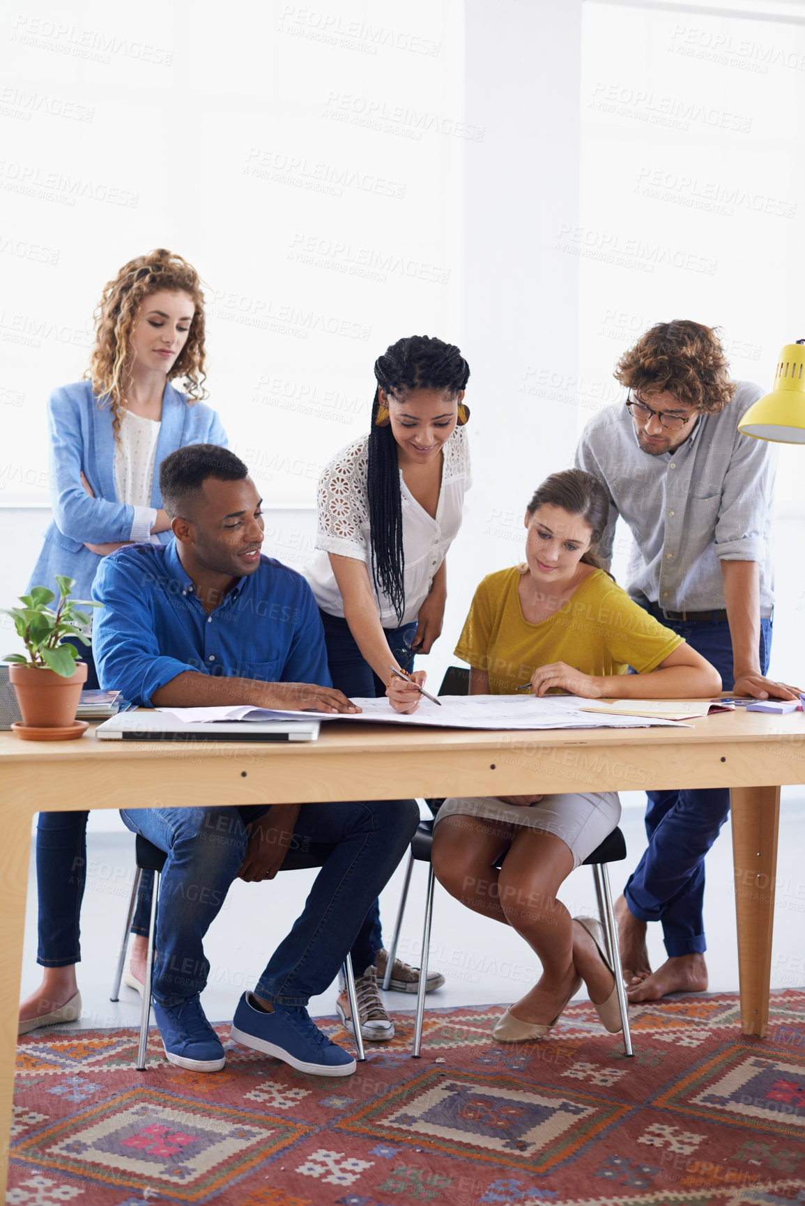 Buy stock photo Diversity, business people and blueprint in meeting for planning, construction or strategy at the office. Architect group working together on document in collaboration for floor plan at the workplace