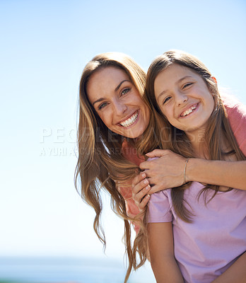 Buy stock photo Portrait of a loving mother and daughter standing together in the outdoors