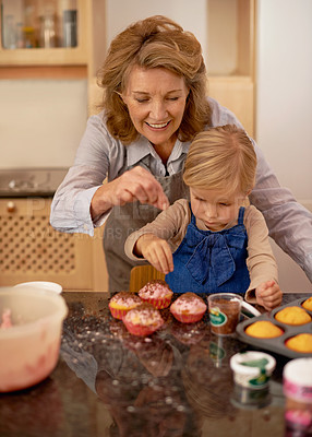 Buy stock photo Help, grandmother and child in kitchen for baking cupcake with sprinkle. Home, chef for growth and development with family and creativity for dessert ingredients, smile for fun activity apron