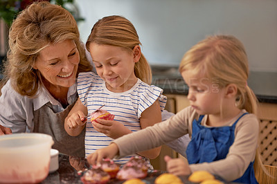 Buy stock photo Grandmother, children and baking cupcake or teaching with icing decorations or learning creativity, bonding or teamwork. Woman, siblings and sweet dessert or helping with ingredients, snack or fun