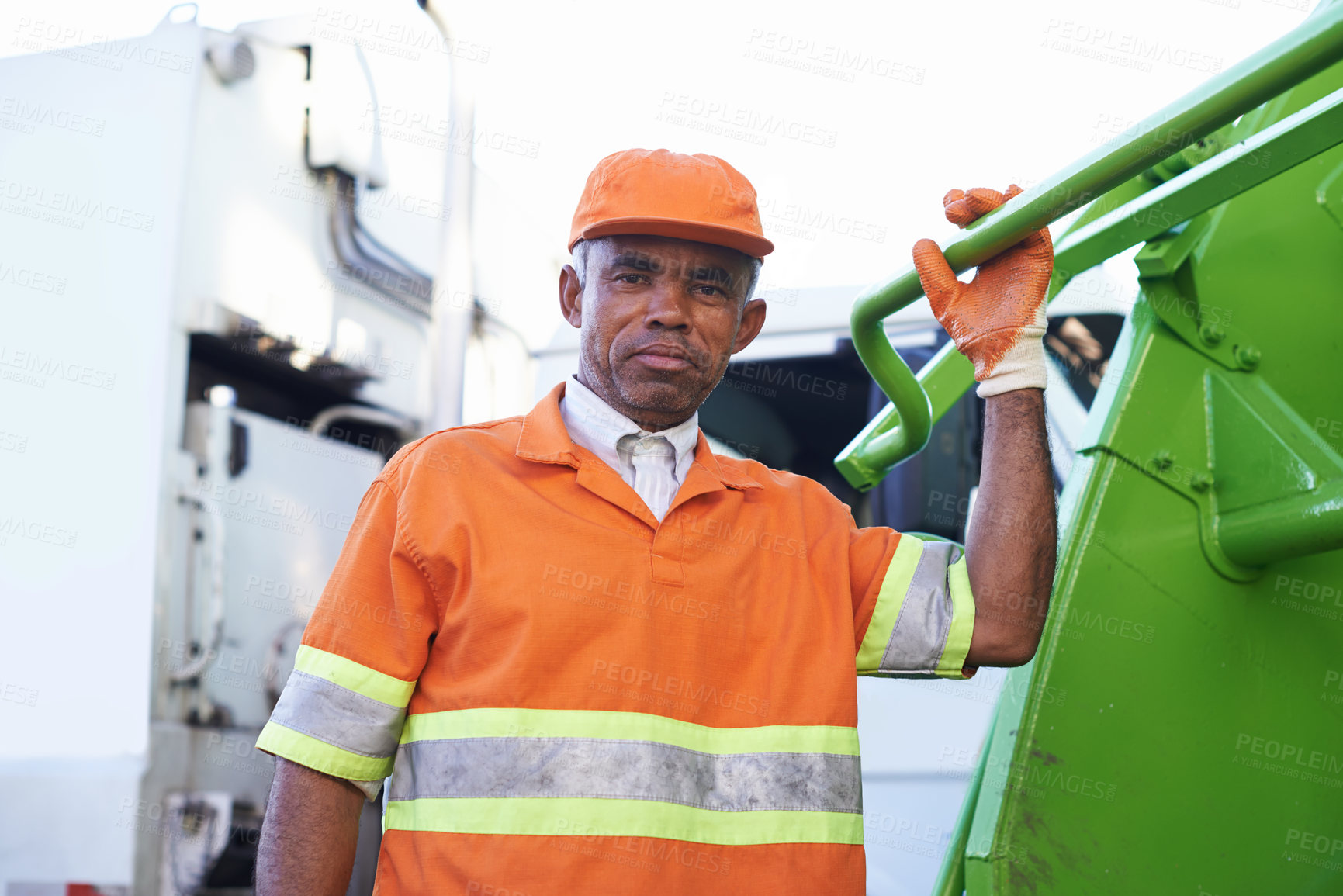 Buy stock photo Cropped shot of a male worker on garbage day