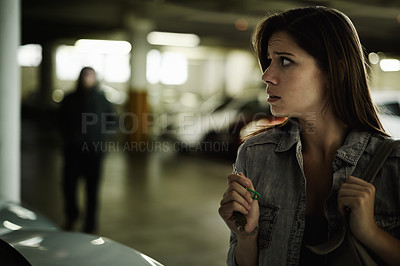 Buy stock photo Female person, suspicious and parking lot with anxiety, worried and stressed for safety and concern. Woman, in danger and scared with backpack, terror and afraid for scary place and living in fear