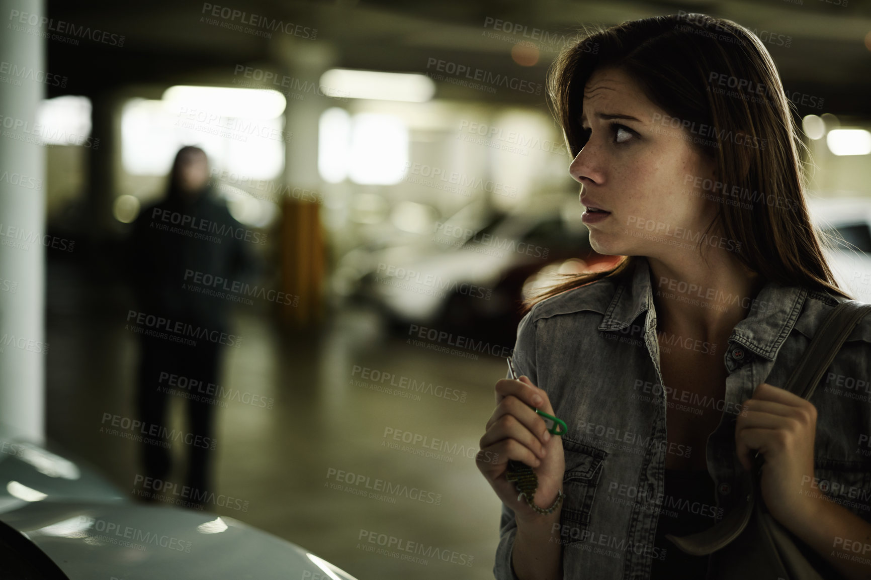 Buy stock photo Female person, suspicious and parking lot with anxiety, worried and stressed for safety and concern. Woman, in danger and scared with backpack, terror and afraid for scary place and living in fear