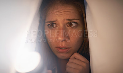 Buy stock photo Flashlight, scared and woman with blanket on bed with anxiety, stress or risk for mystery. Torch, fear and young female person with duvet for protection of horror, terror or danger with panic.