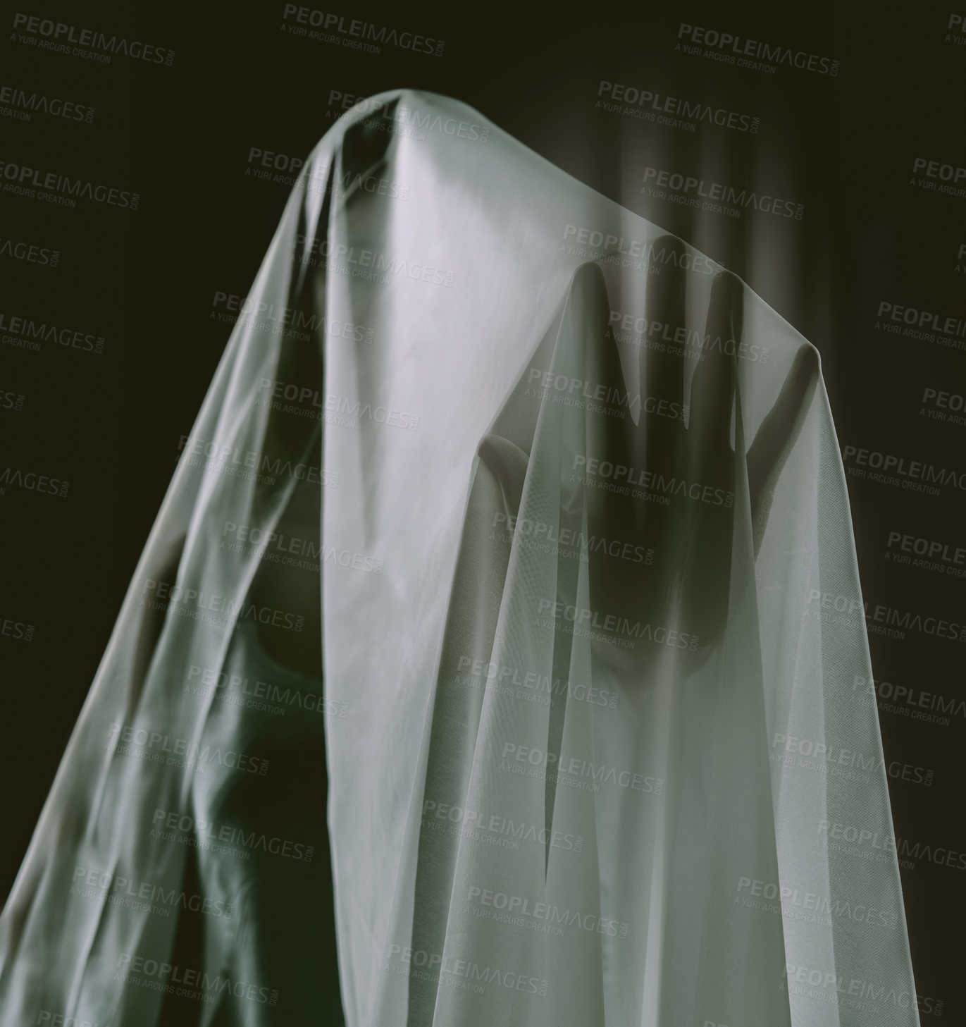 Buy stock photo Horror, dark and scary ghost in sheet on black background with haunting silhouette. Supernatural, spooky and shadow hand of spirit, lost soul or monster in studio with paranormal fear of death