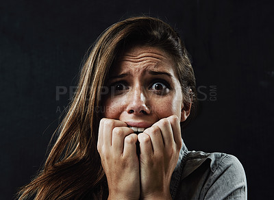 Buy stock photo Portrait, mental health and woman biting nails in studio on black background for reaction to fear or panic. Face, stress and horror with scared young person in dark for drama, nightmare or terror
