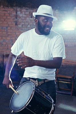 Buy stock photo Smiling, black man and playing drum or music for event, concert with percussion and entertainment. Festival, performance and beats on rhythm for band of a creative on stage with white shirt and hat