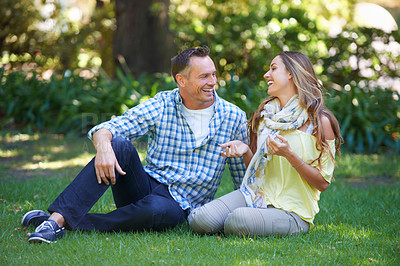 Buy stock photo Relax, chat and couple laughing on grass for summer romance, park and fun outdoor date. Love, mature man and happy woman in garden with morning sunshine, conversation and marriage bonding in nature.