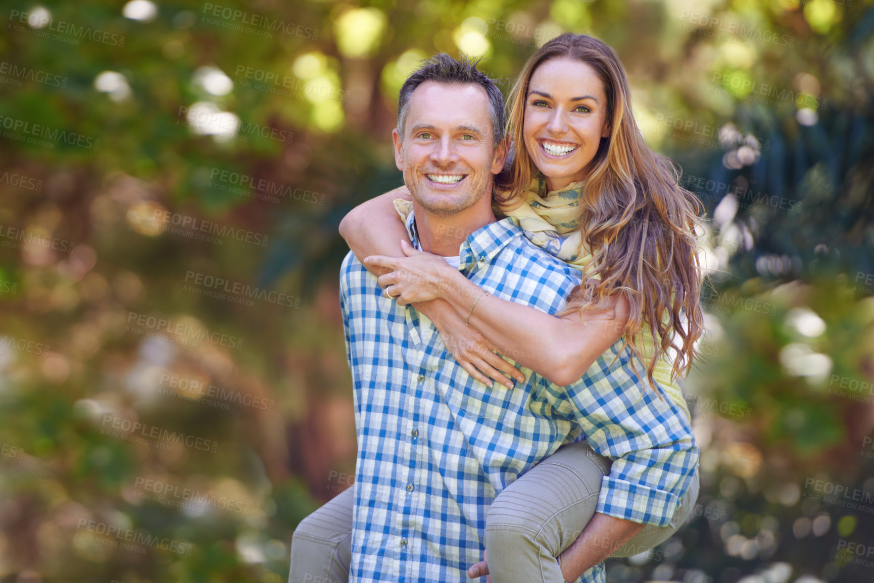 Buy stock photo Mature couple, portrait and woman on piggyback, outside and garden for anniversary. Affectionate, happy and Autumn sun for loving, smile and romantic relationship for Canadian husband and wife