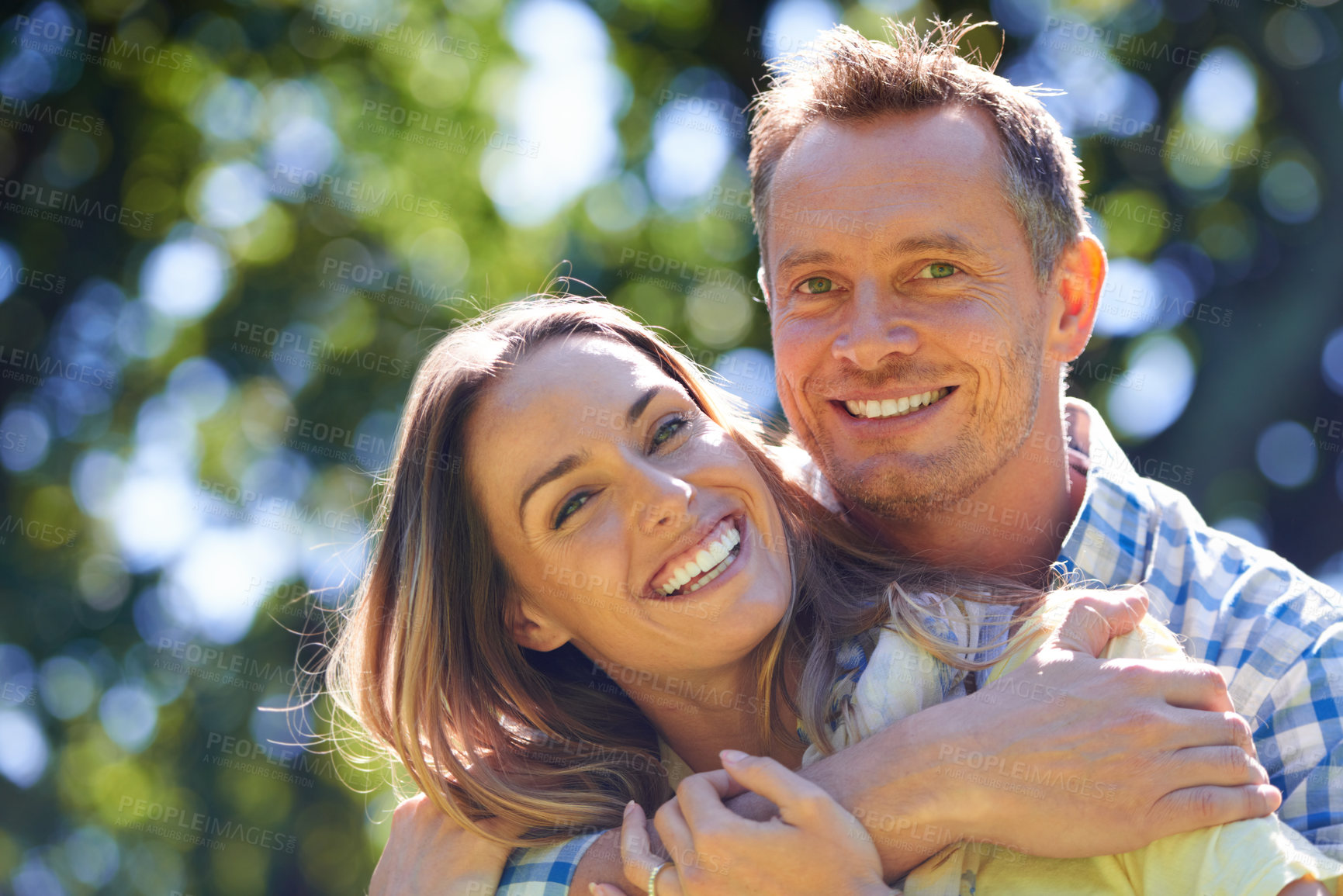 Buy stock photo Portrait of an affectionate couple outside in the summer sun