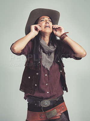 Buy stock photo Crying, cowgirl and unhappy with sad expression in studio with stress, tears and upset with sorrow. Female person, costume and hat for western fashion, isolated and emotional with grey background