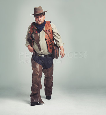 Buy stock photo Portrait, serious and criminal cowboy in studio mockup, outlaw and wild west character with pistol. Overweight texas man, bandit face or gun belt for fighting, western or cigar by white background