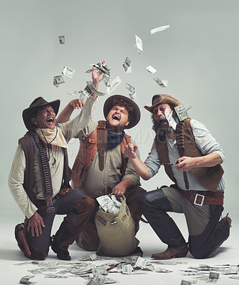 Buy stock photo Money, thief and western with celebration of people in studio on gray background for robbery or heist. Texas, crime and smile with man gang throwing cash from bag in air for illegal theft or stealing