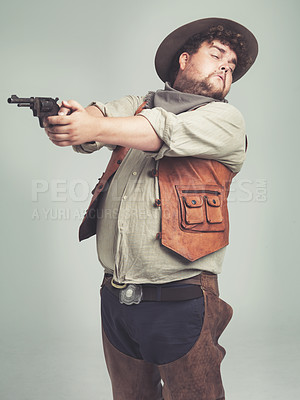 Buy stock photo Cowboy, man and shooting gun in studio, weapon and pistol  with western costume isolated on white background. Plus size, criminal or funny person with revolver, guess aim or scared with fear in Texas