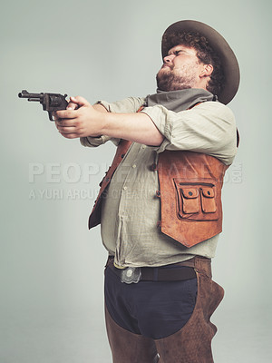 Buy stock photo Cowboy, western man and shooting gun, weapon and pistol in studio with costume isolated on a white background. Plus size, criminal and male person with revolver, aim and scared with fear in Texas