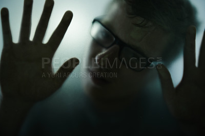 Buy stock photo Scary, mystery and man with hands on glass, window and trapped in home. Person, shadow and figure in horror, drama or creepy aesthetic with silhouette of prisoner in house with fog on screen