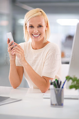 Buy stock photo Cropped shot of a businesswoman using her cellphone at her desk