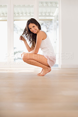 Buy stock photo Morning, space and portrait of happy woman in house for resting in bedroom pajamas to relax alone. Floor mockup, peace or female person on break with smile or squat ready to start day for wellness