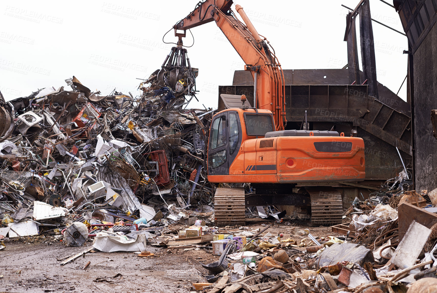 Buy stock photo Cropped shot of an excavator sorting through a pile of scrap metal