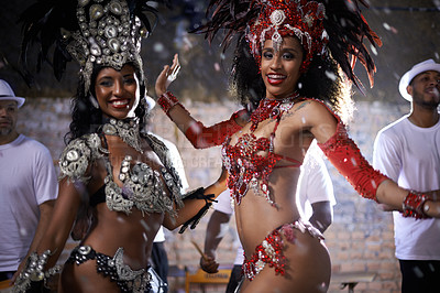 Buy stock photo Samba, portrait and performance of women in Rio de Janeiro, smile and dancing for crowd with energy. Female people, artistic and clothes from feather for fashion with culture, music and celebration